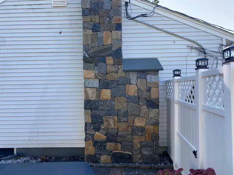 Stone veneer chimney and fireplace